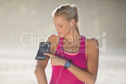 Woman listening music on mobile phone