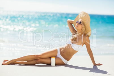 Woman with sun cream on beach