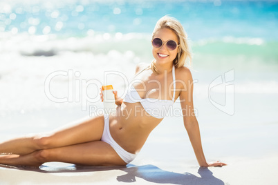 Woman with sun cream on beach