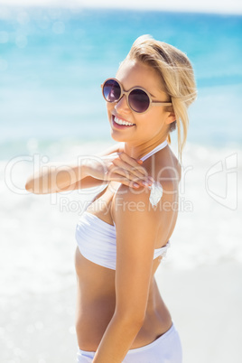 Woman applying sun cream on her shoulder