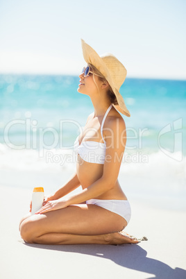 Woman with sunscreen on beach