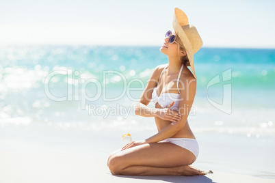 Woman applying sunscreen on her hand