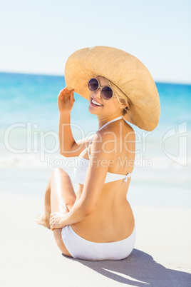 Young woman in bikini posing with hat