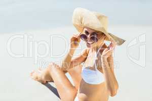 Young woman in bikini posing with sunglasses