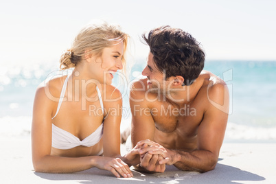 Young couple lying on beach