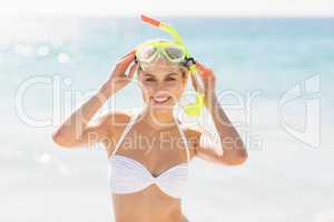 Woman posing with diving mask on beach