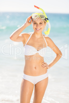Woman posing with diving mask on beach