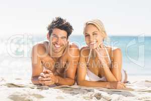 Young couple lying on beach