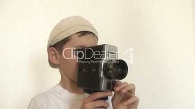 Boy shoots a film on 8mm movie camera