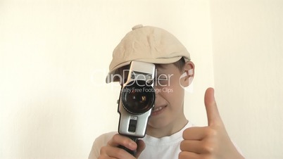 Boy shoots a film on 8mm movie camera