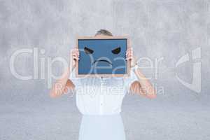Compositeimage of woman is holding a chalkboard with unsmiling f