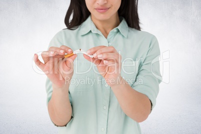 Composite image of woman is breaking a cigarette