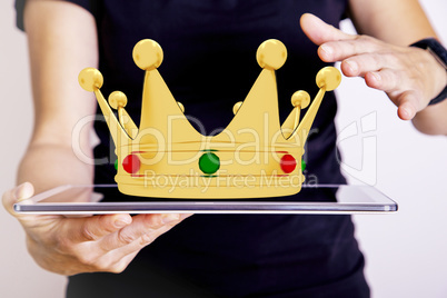 Hand with tablet PC holds golden crown, 3D Illustration