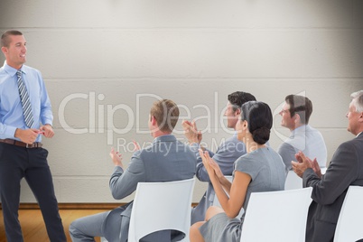 Composite image of businesspeople are applauding a businessman