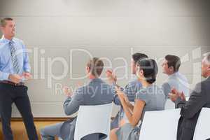 Composite image of businesspeople are applauding a businessman