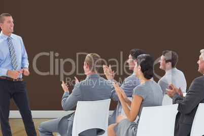 Composite image of businesspeople are applauding a businessman