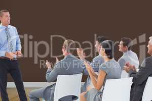 Composite image of businesspeople are applauding a businessman
