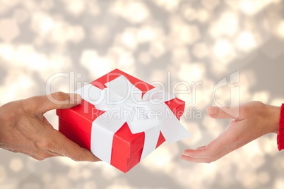 Composite image of a man is giving a gift to a woman