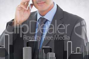 Composite image of businessman is talking on the phone