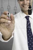Composite image of businessman is drawing light bulb