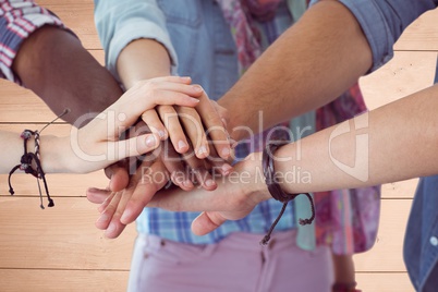 Composite image of friends is joining their hands together