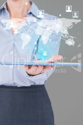 Composite image of businesswoman is holding a tablet with a holo