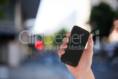 Composite image of hand is holding a smartphone