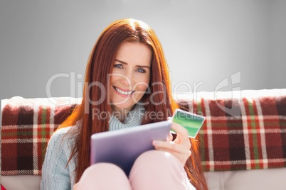 Composite image of woman is doing shopping online