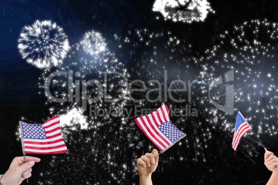 Composite image of hands is shaking american flags