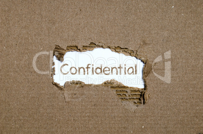 The word Confidential appearing behind torn paper.