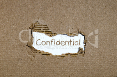 The word Confidential appearing behind torn paper.