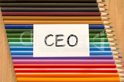 Blank white paper and colored pencil on wooden background