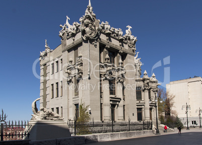 chimera house with stone gargoyle, demons, monsters on its roof and decoration gothic style photo