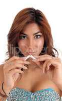 Closeup of woman breaking cigarette.