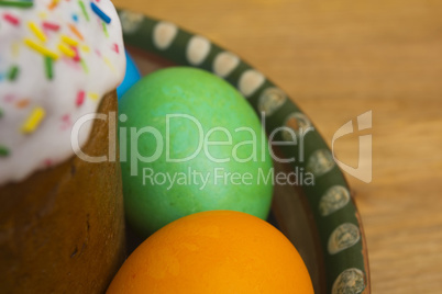 Easter eggs of different colors and cake