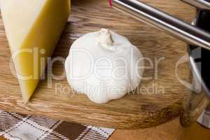 Garlic and cheese on a cutting board