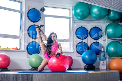 Beautiful sporty woman trains in modern gym