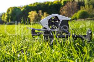 Dron is located in the green grass before takeoff