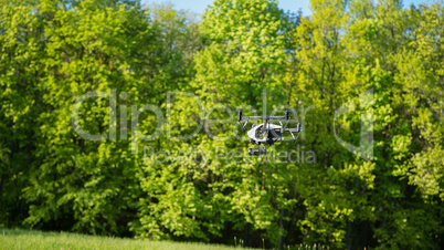 Flying drone is filming in the forest background