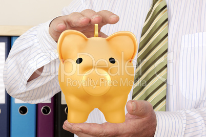 Hand holding piggy bank