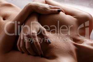 Portrait of naked female body with water drops