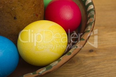 Easter eggs of different colors and cake