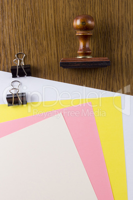 Wooden stamp and colored sheets of paper