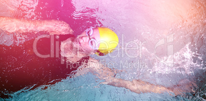 Fit female swimmer doing the back stroke