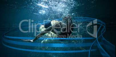Composite image of athletic swimmer doing a somersault underwater