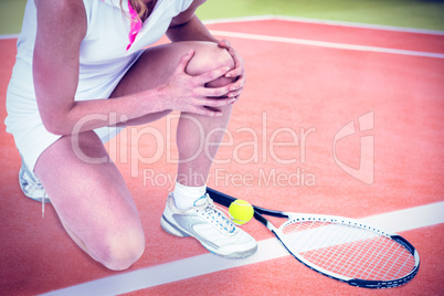 Composite image of injured athlete with tennis racket and tennis