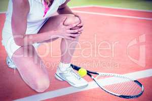 Composite image of injured athlete with tennis racket and tennis