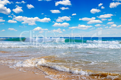 ocean, sandy beach and blue sky