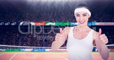 Composite image of female athlete showing thumbs up