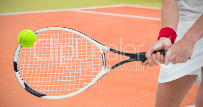 Composite image of athlete playing tennis with a racket